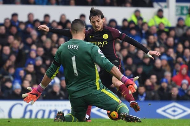 Everton goalkeeper Joel Robles keeps out Manchester City's David Silva