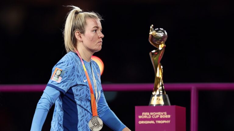 Lauren Hemp of England walks past the FIFA Women's World Cup Trophy at the award ceremony following the FIFA Women's World Cup Australia & New Zealand 2023 Final match between Spain and England at Stadium Australia