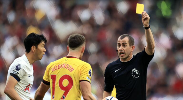Referee Peter Bankes shows a yellow card to Jack Robinson of Sheffield United during the Premier League match between Spurs and Sheff Utd at Tottenham Hotspur Stadium on September 16, 2023