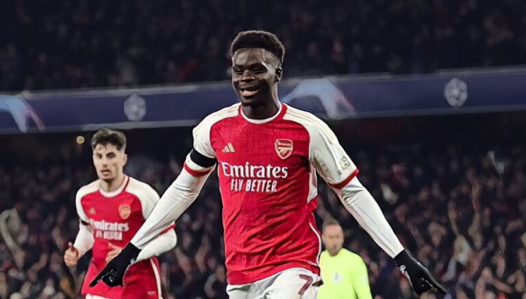 Bukayo Saka of Arsenal celebrates after scoring his side's third goal during the UEFA Champions League match between Arsenal FC and RC Lens at Emirates Stadium on November 29, 2023 in London, England.