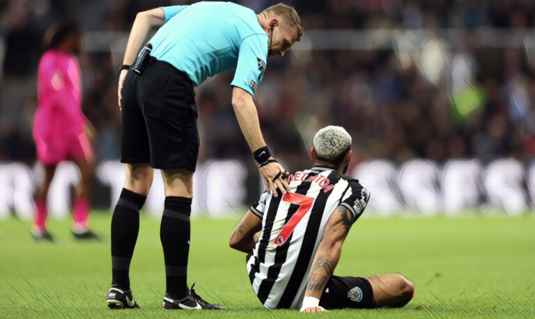 Joelinton of Newcastle United (R) speaks with referee Sam Barrott before being substituted off injured during the Premier League match between Newcastle United and Fulham FC at St. James Park on December 16, 2023