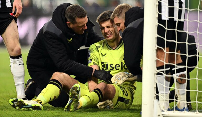 Nick Pope of Newcastle United receives medical treatment after suffering with an injury during the Premier League match between Newcastle United and Man Utd at St. James Park on December 02, 2023