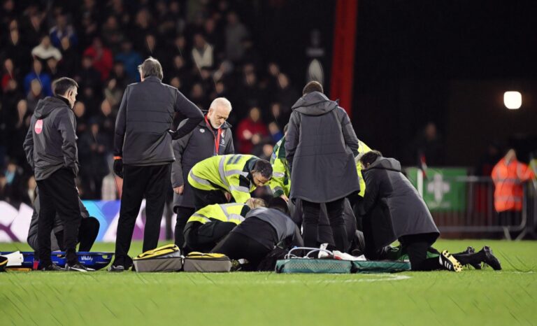 Tom Lockyer of Luton Town (obscured) receives medical treatment after collapsing during the Premier League match between AFC Bournemouth and Luton Town at Vitality Stadium on December 16, 2023.