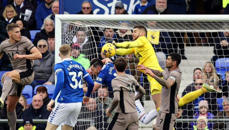 Guglielmo Vicario of Tottenham Hotspur makes a save under pressure from Jack Harrison of Everton during the Premier League match between Everton FC and Tottenham Hotspur at Goodison Park on February 03, 2024