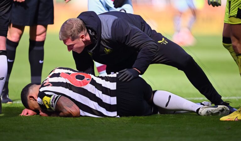 Jamaal Lascelles of Newcastle United receives medical treatment after going down with an injury during the Premier League match between Newcastle Utd and West Ham United at St. James Park on March 30, 2024 in Newcastle upon Tyne, England.