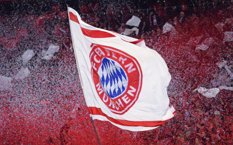 Fans wave a Bayern Munich flag during the UEFA Champions League Quarter Final second leg match between FC Bayern München and Manchester United at Allianz Arena on April 9, 2014 in Munich, Germany.