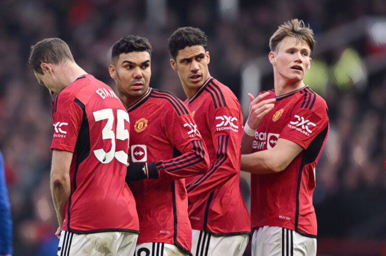 Casemiro, Raphael Varane and Scott McTominay of Manchester United form a wall during the Premier League match between Manchester United and Everton FC at Old Trafford on March 09, 2024 in Manchester, England.