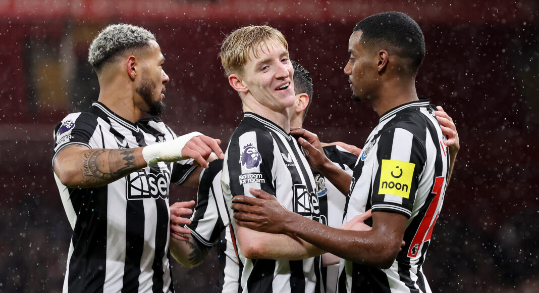 Alexander Isak of Newcastle United celebrates with team mate Anthony Gordon after scoring their side's first goal during the Premier League match between Liverpool FC and Newcastle United at Anfield on January 01, 2024 in Liverpool, England.
