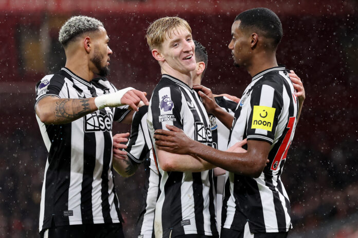 Alexander Isak of Newcastle United celebrates with team mate Anthony Gordon after scoring their side's first goal during the Premier League match between Liverpool FC and Newcastle United at Anfield on January 01, 2024 in Liverpool, England.