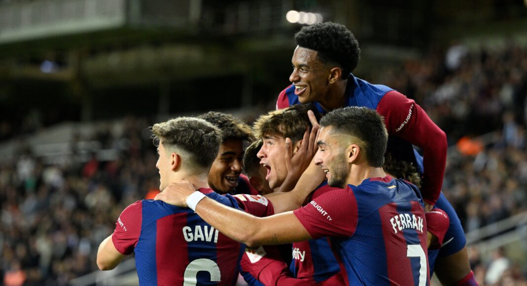 Barcelona's Spanish forward #38 Marc Guiu celebrates with teammates after scoring his team's first goal during the Spanish league football match between FC Barcelona and Athletic Club Bilbao at the Estadi Olimpic Lluis Companys in Barcelona on October 22, 2023.