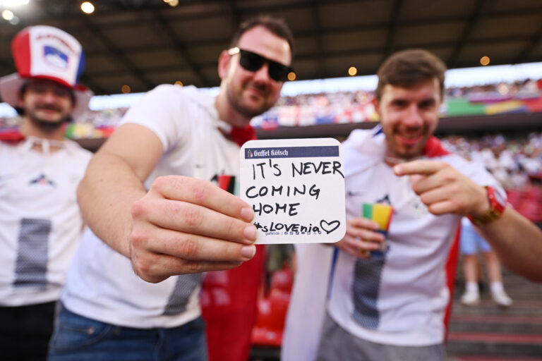 A fan of Slovenia holds up a beermat which reads "Its Never Coming Home #Slovenia" prior to the UEFA EURO 2024 group stage match between England and Slovenia at Cologne Stadium on June 25, 2024 in Cologne, Germany.