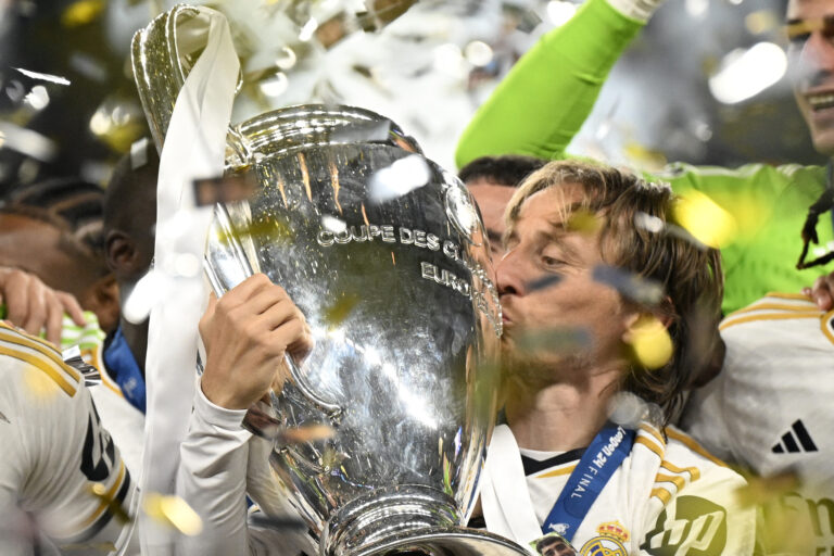 Real Madrid's Croatian midfielder #10 Luka Modric kisses the trophy to celebrate the victory at the end of the UEFA Champions League final football match between Borussia Dortmund and Real Madrid, at Wembley stadium, in London, on June 1, 2024.