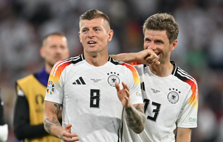 Germany's midfielder #08 Toni Kroos and Germany's forward #13 Thomas Mueller celebrate after winning the UEFA Euro 2024 Group A football match between Germany and Scotland at the Munich Football Arena in Munich on June 14, 2024.