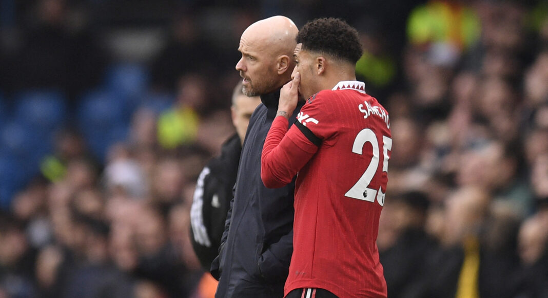 Manchester United's English striker Jadon Sancho (R) speaks with Man United's Dutch manager Erik ten Hag (L) during the English Premier League football match between Leeds United and Man Utd at Elland Road in Leeds, northern England on February 12, 2023