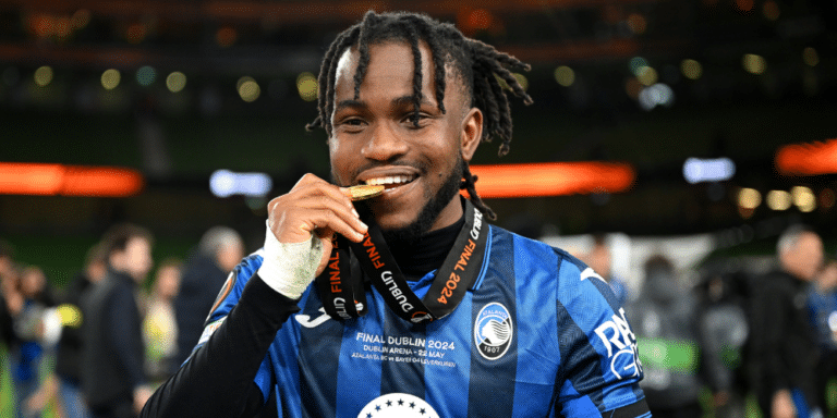 Atalanta winger Ademola Lookman takes a bite of his Europa League medal.