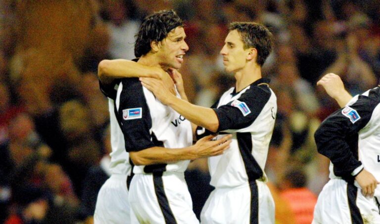 Manchester United's Ruud van Nistelrooy (L) is congratulated by his teammates Gary Neville (C) Nicky Butt (2nd R) and Jaap Stam (R) after scoring a goal during the F.A Community Shield between Man Utd and Liverpool at The Millenium Stadium in Cardiff 12 August 2001.