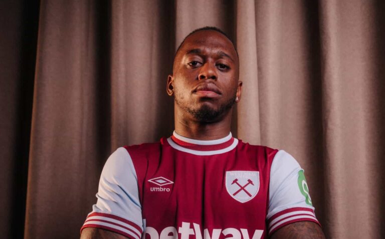 Aaron Wan-Bissaka poses in a West Ham United jersey following his transfer from Man Utd.