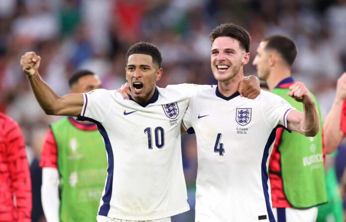 Jude Bellingham and former Ireland international Declan Rice celebrate after England's victory and progression to the quarter final in the UEFA EURO 2024 round of 16 match between England and Slovakia at Arena AufSchalke on June 30, 2024 in Gelsenkirchen, Germany.