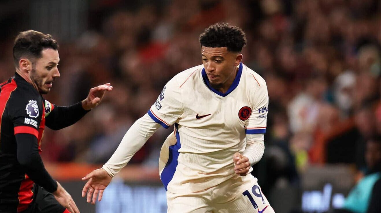 Jadon Sancho of Chelsea runs with the ball under pressure from Adam Smith of AFC Bournemouth during the Premier League match between AFC Bournemouth and Chelsea FC at Vitality Stadium on September 14, 2024 in Bournemouth, England.