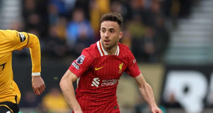 Diogo Jota of Liverpool runs with the ball during the Premier League match between Wolverhampton Wanderers FC and Liverpool FC at Molineux on September 28, 2024 in Wolverhampton, England.