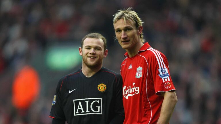 Wayne Rooney of Man Utd smiles as Sami Hyypia of Liverpool looks on during the Barclays Premier League match between Liverpool and Manchester United at Anfield on December 16, 2007 in Liverpool, England.
