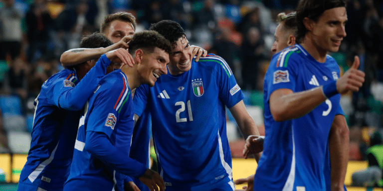Italy players celebrate together.