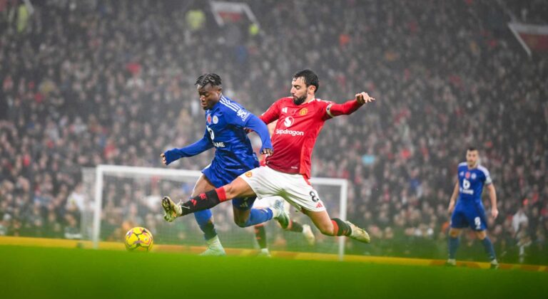 Abdul Fatawu of Leicester and Bruno Fernandes of Man Utd in action during the Premier League match between Manchester United FC and Leicester City FC at Old Trafford on November 10, 2024 in Manchester, England.