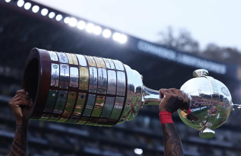 Detail of the trophy as a player of Flamengo holds it after winning the final of Copa CONMEBOL Libertadores 2022 between Flamengo and Atletico Paranaense at Estadio Monumental Isidro Romero Carbo on October 29, 2022 in Guayaquil, Ecuador.