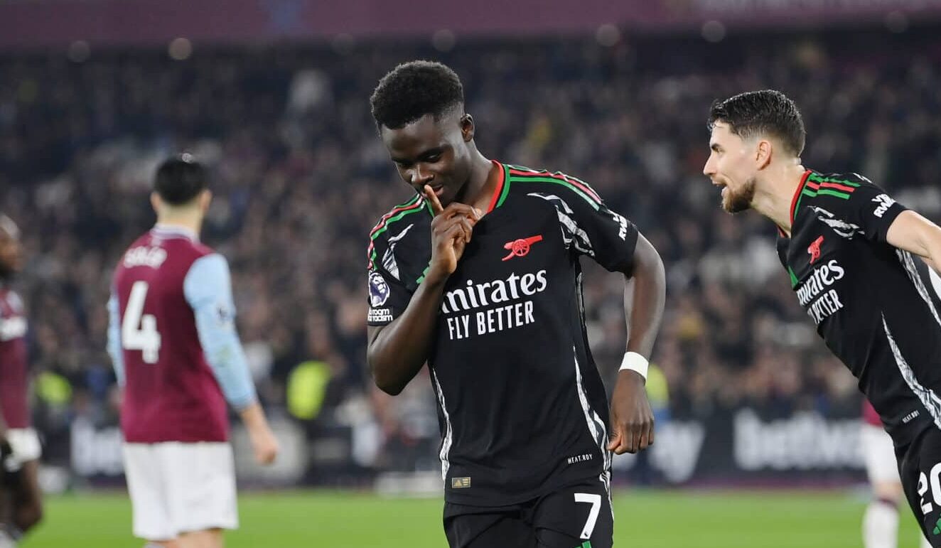 Bukayo Saka of Arsenal celebrates scoring his team's fifth goal from a penalty kick during the Premier League match between West Ham United FC and Arsenal FC at London Stadium on November 30, 2024 in London, England.