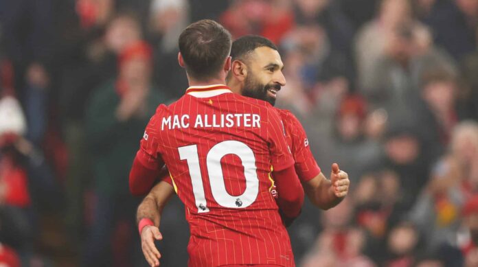 Mo Salah of Liverpool celebrates scoring his team's third goal with teammate Alexis Mac Allister during the Premier League match between Liverpool FC and Leicester City FC at Anfield on December 26, 2024 in Liverpool, England.