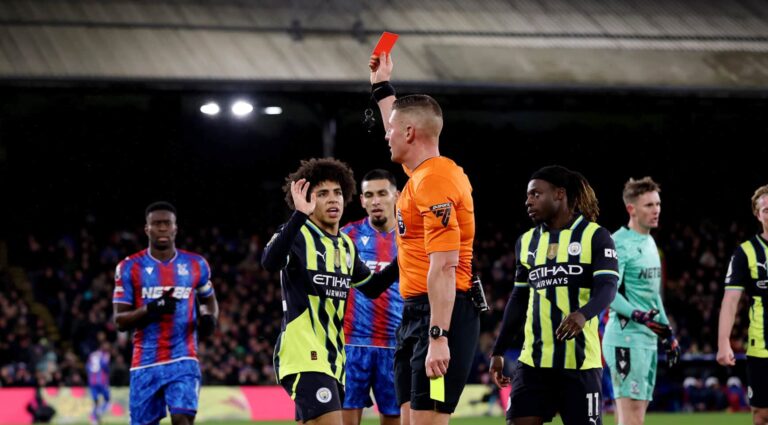 Rico Lewis of Manchester City is shown a red card, his second yellow by match referee Robert Jones during the Premier League match between Crystal Palace FC and Manchester City FC at Selhurst Park on December 07, 2024 in London, England.