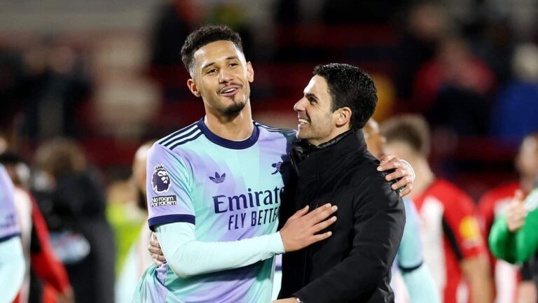 Mikel Arteta, Manager of Arsenal, interacts with William Saliba of Arsenal after the Premier League match between Brentford FC and Arsenal FC at the Brentford Community Stadium on January 01, 2025 in Brentford, England.