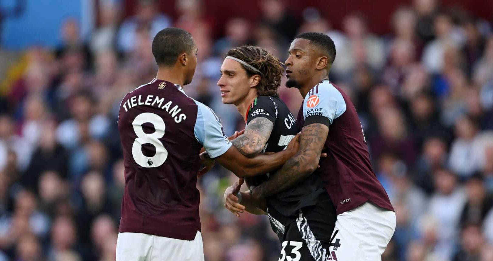 Riccardo Calafiori of Arsenal clashes with Ezri Konsa and Youri Tielemans of Aston Villa during the Premier League match between Aston Villa FC and Arsenal FC at Villa Park on August 24, 2024 in Birmingham, England.