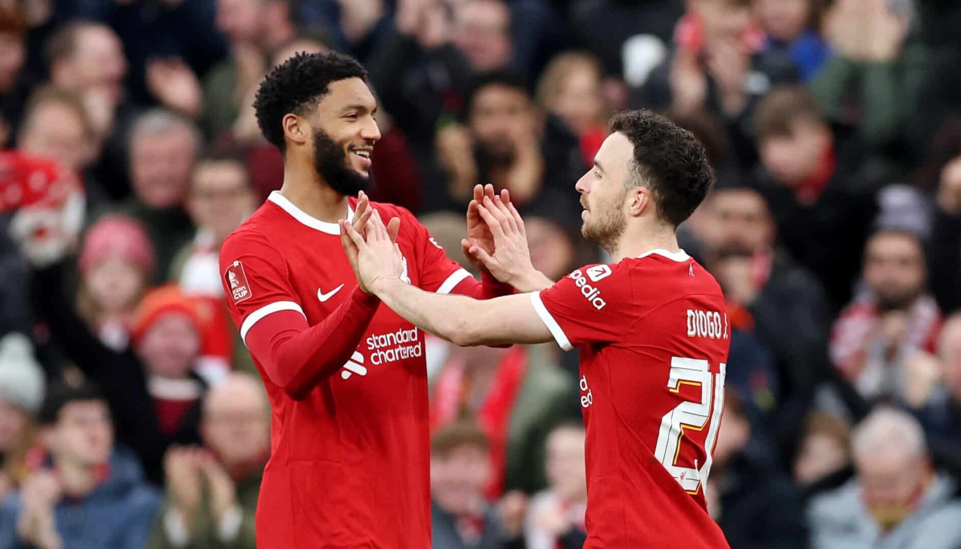 Diogo Jota of Liverpool celebrates with Joe Gomez of Liverpool after scoring his team's third goal during the Emirates FA Cup Fourth Round match between Liverpool and Norwich City at Anfield on January 28, 2024 in Liverpool, England.