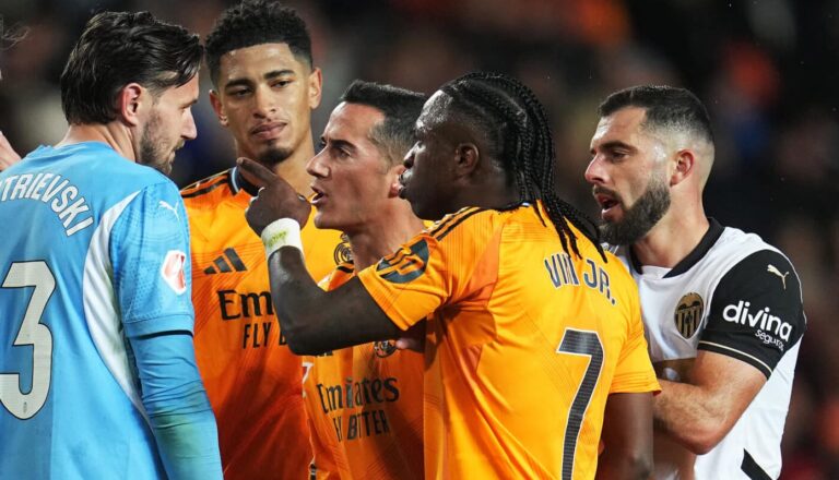 Vinicius Jr of Real Madrid reacts towards Stole Dimitrievski of Valencia CF after an earlier incident between them and is later shown a red card during the LaLiga match between Valencia CF and Real Madrid CF at Estadio Mestalla on January 03, 2025 in Valencia, Spain.