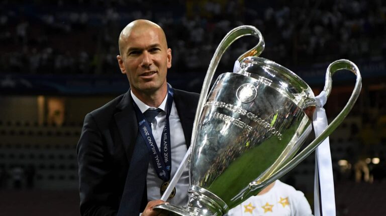 Real Madrid head coach Zinedine Zidane shows the trophy after winning the UEFA Champions League Final match between Real Madrid and Club Atletico de Madrid at Stadio Giuseppe Meazza on May 28, 2016 in Milan, Italy.