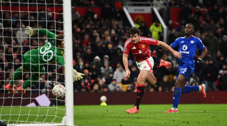 Man United defender Harry Maguire scores his team's second goal past Mads Hermansen of Leicester City during the Emirates FA Cup Fourth Round match between Manchester United and Leicester City at Old Trafford on February 07, 2025 in Manchester, England.