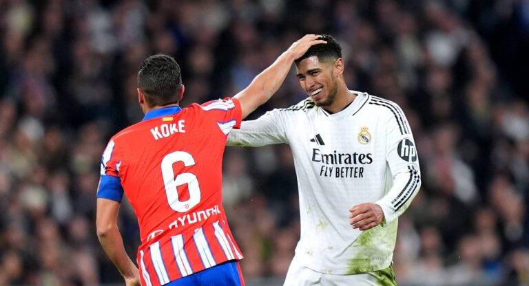 Koke of Atletico de Madrid interacts with Jude Bellingham of Real Madrid during the LaLiga match between Real Madrid CF and Atletico de Madrid at Estadio Santiago Bernabeu on February 08, 2025 in Madrid, Spain.