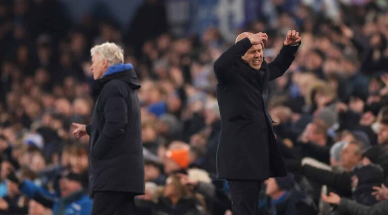 Arne Slot, Manager of Liverpool, reacts as David Moyes looks on during the Premier League match between Everton FC and Liverpool FC at Goodison Park on February 12, 2025 in Liverpool, England.