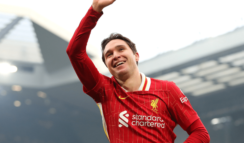 Liverpool player Federico Chiesa waves to the fans at Anfield during a Premier League match.