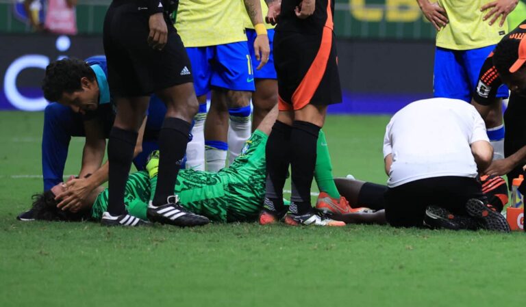 Liverpool goalkeeper Alisson Becker of Brazil and Davinson Sanchez of Colombia receive medical attention after suffering a head injury during the South American FIFA World Cup 2026 Qualifier match between Brazil and Colombia at Mane Garrincha Stadium on March 20, 2025 in Brasilia, Brazil.