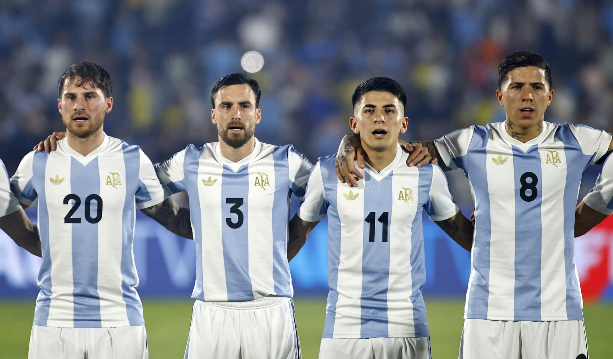 Argentina players (L-R) Alexis Mac Allister, Nicolas Tagliafico, Thiago Almada and Enzo Fernández of Argentina sing the national anthem prior to the South of American FIFA World Cup 2026 Qualifier match between Uruguay and Argentina at Centenario Stadium on March 21, 2025 in Montevideo, Uruguay.