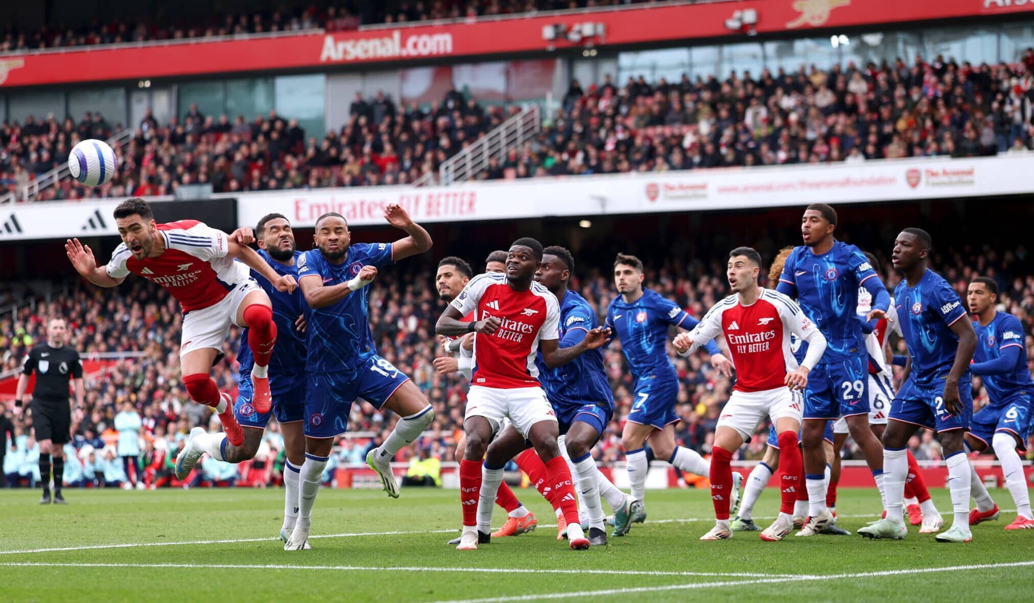 Mikel Merino of Arsenal scores his team's first goal whilst under pressure from Reece James and Christopher Nkunku of Chelsea during the Premier League match between Arsenal FC and Chelsea FC at Emirates Stadium on March 16, 2025 in London, England.