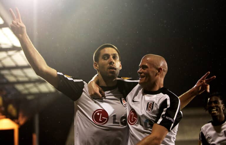 Fulham player Clint Dempsey (L) celebrates scoring with Paul Konchesky during the UEFA Europa League Round of 16 second leg match between Fulham and Juventus at Craven Cottage on March 18, 2010 in London, England.