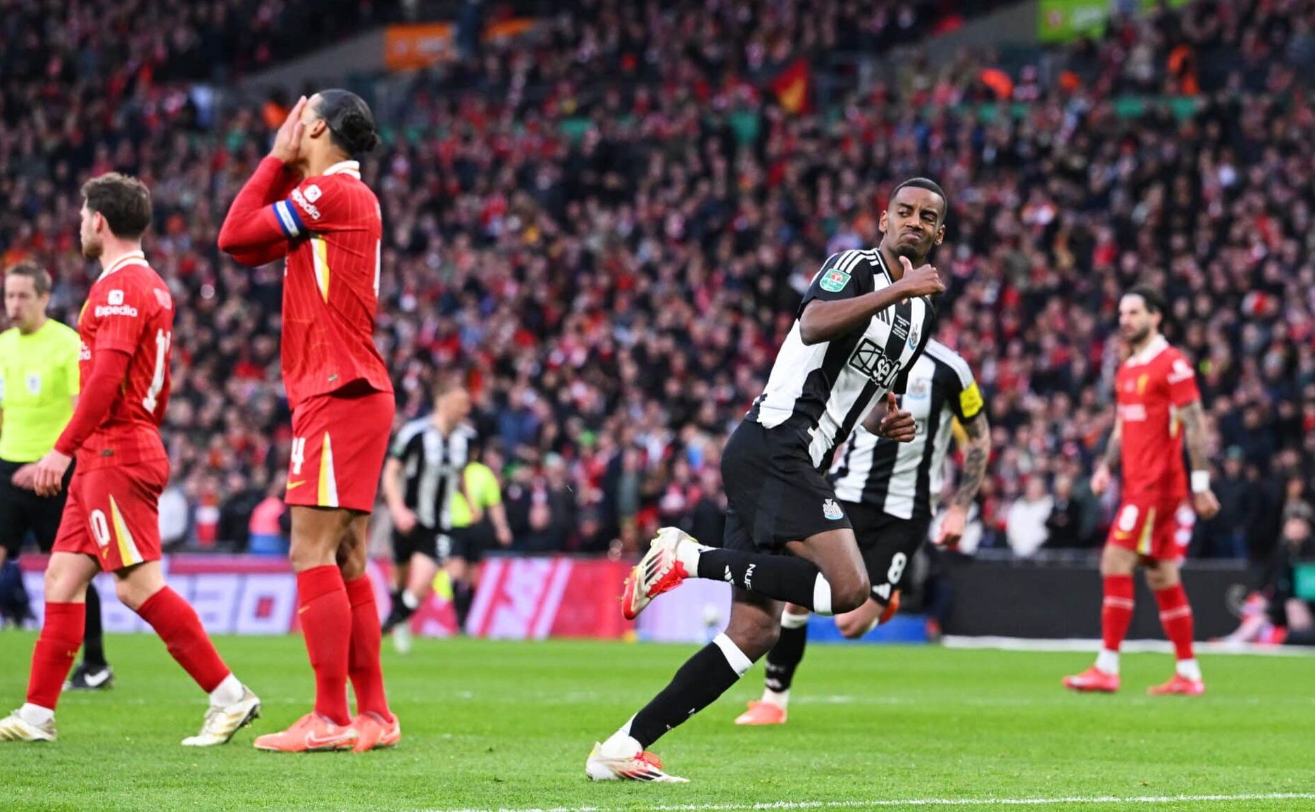 Alexander Isak of Newcastle United celebrates scoring his team's second goal as Virgil van Dijk of Liverpool looks dejected during the Carabao Cup Final between Liverpool and Newcastle United at Wembley Stadium on March 16, 2025 in London, England.