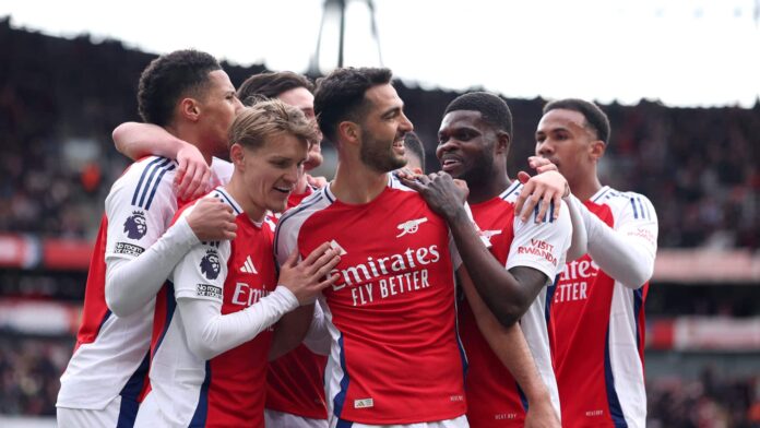 Mikel Merino of Arsenal celebrates scoring his team's first goal with teammates during the Premier League match between Arsenal FC and Chelsea FC at Emirates Stadium on March 16, 2025 in London, England.