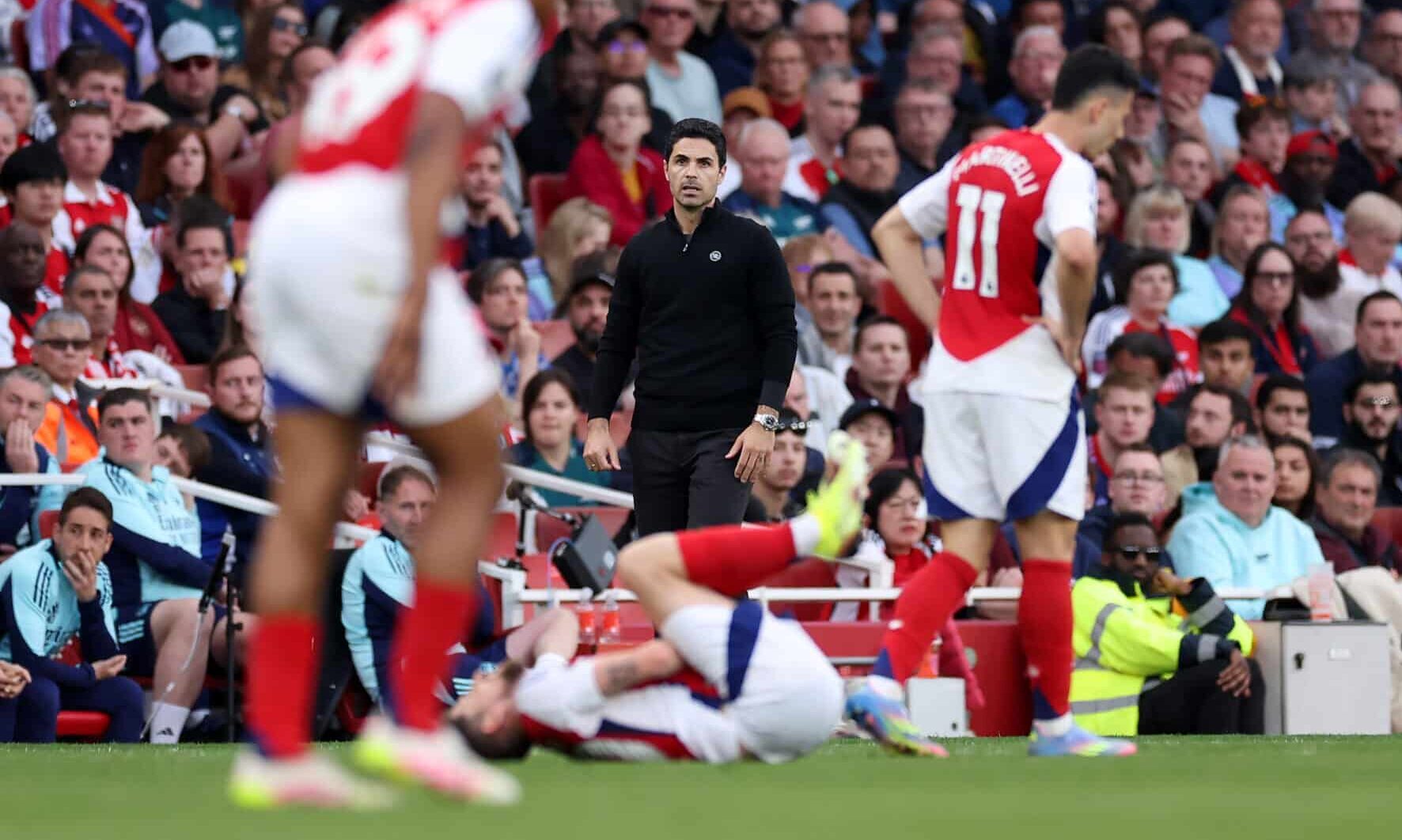 Arsenal manager Mikel Arteta looks on as Jorginho of Arsenal goes down injured during the Premier League match between Arsenal FC and Brentford FC at Emirates Stadium on April 12, 2025 in London, England.