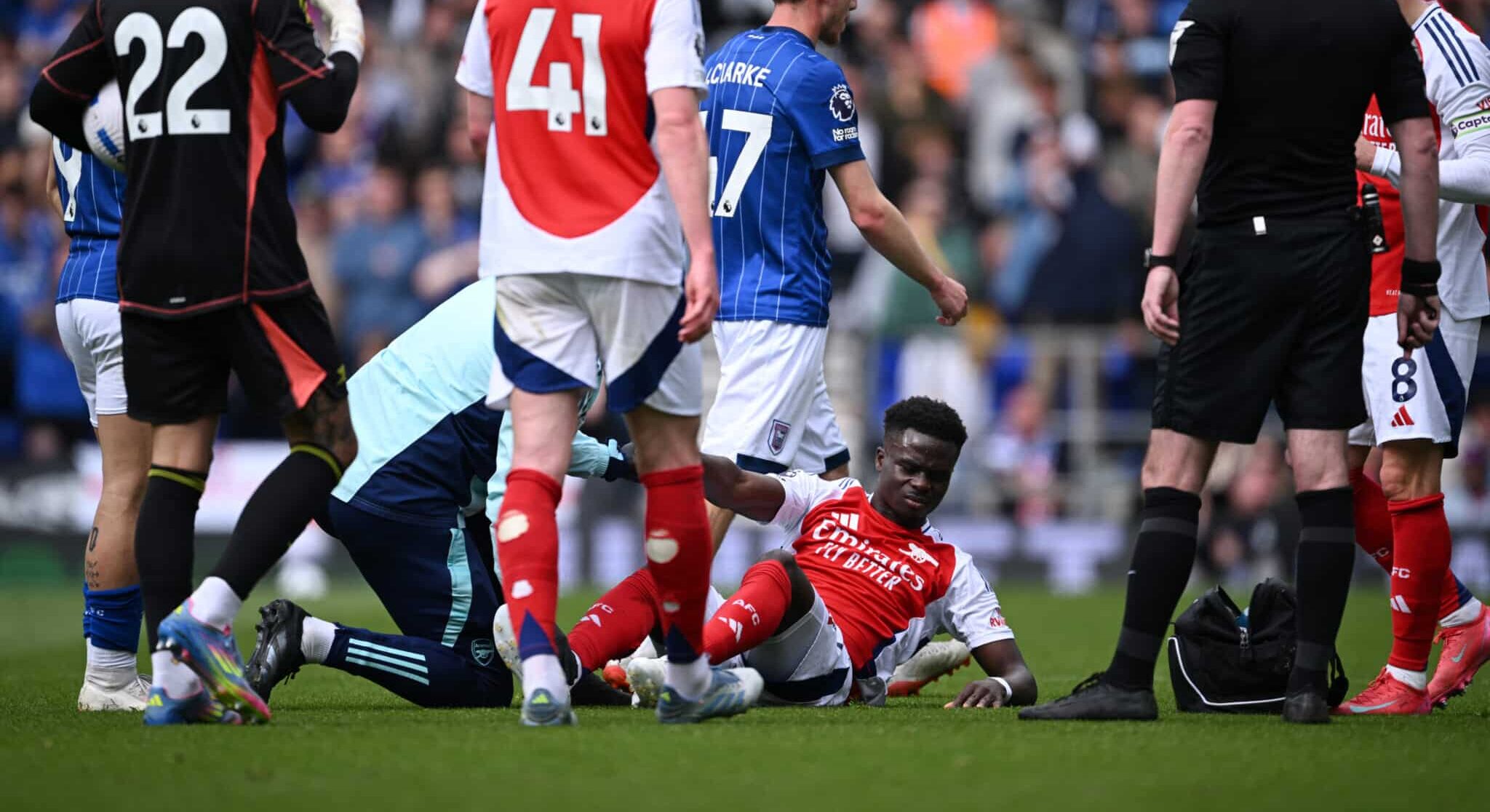 Bukayo Saka of Arsenal receives medical treatment for an injury during the Premier League match between Ipswich Town FC and Arsenal FC at Portman Road on April 20, 2025 in Ipswich, England.