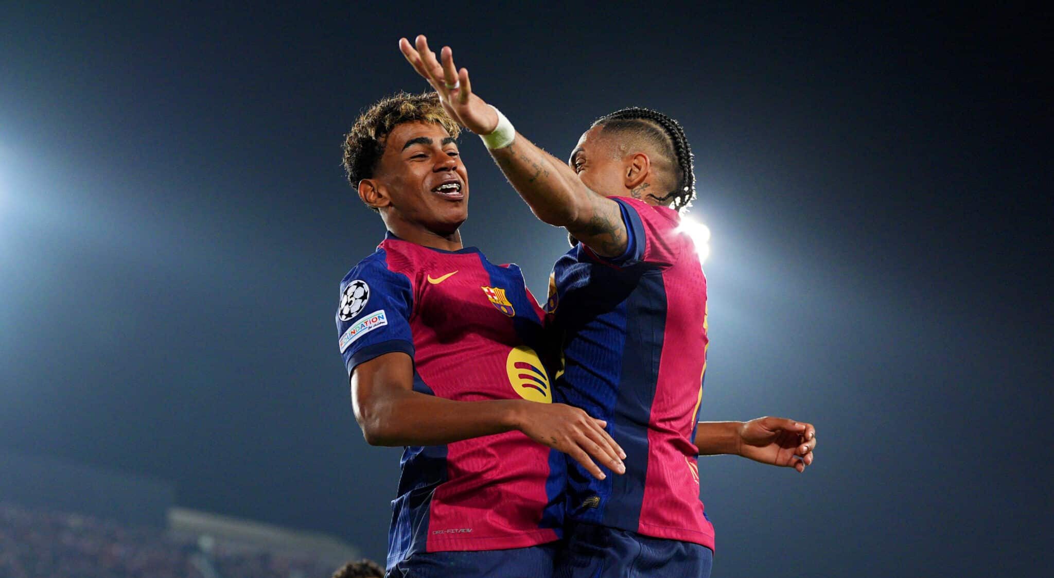 Lamine Yamal of FC Barcelona (L) celebrates scoring his team's fourth goal with teammate Raphinha (R) during the UEFA Champions League 2024/25 Quarter Final First Leg match between FC Barcelona and Borussia Dortmund at Estadi Olimpic Lluis Companys on April 09, 2025 in Barcelona, Spain.