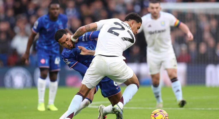 Morgan Rogers of Aston Villa is challenged by Levi Colwill of Chelsea during the Premier League match between Chelsea FC and Aston Villa FC at Stamford Bridge on December 01, 2024 in London, England.